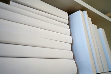 Image showing Shelf with white books