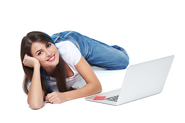 Image showing Woman lying on the floor with laptop