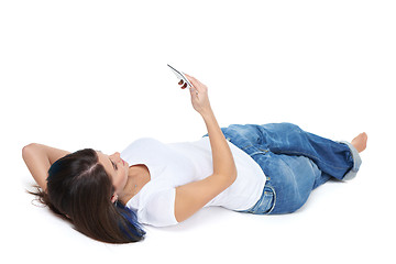 Image showing Woman lying on her back and using phone