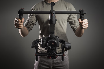 Image showing Professional videographer with gimball video slr