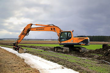 Image showing  Hyundai Robex 210LC-9 Crawler Excavator on a Field at Spring