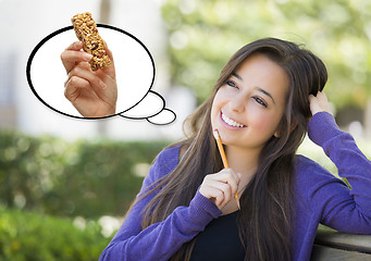 Image showing Pensive Woman with Snack Bar Inside Thought Bubble