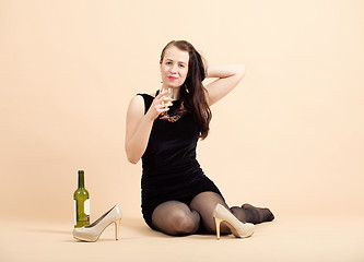 Image showing beautiful young brunette woman holding a glass of white wine