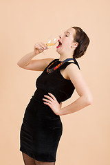 Image showing beautiful young brunette woman holding a glass of white wine