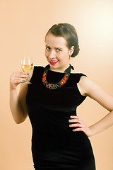 Image showing beautiful young brunette woman holding a glass of white wine
