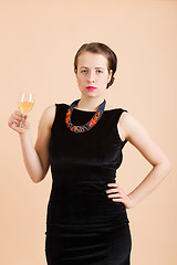 Image showing beautiful young brunette woman holding a glass of white wine