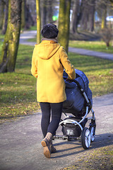 Image showing Young mother with  pram 