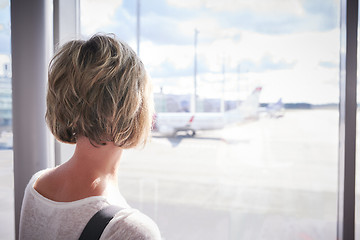 Image showing Woman at the airport window 