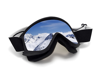 Image showing Ski goggles with reflection of mountains at sun day