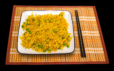 Image showing Rice with vegetables and chopsticks on bamboo mat