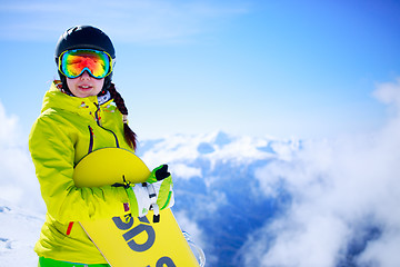 Image showing View of sportsman with snowboard standing in the mountain