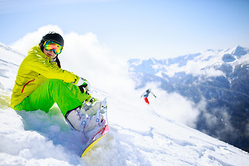 Image showing Snowboarder sitting