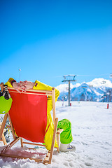 Image showing Women at mountains in winter lies on sun-lounger