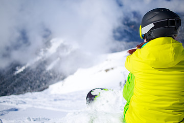 Image showing Snowboarder sitting