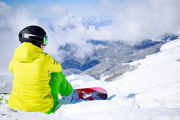 Image showing Snowboarder sitting