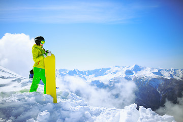 Image showing snowboarder against sun and mountains