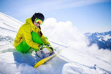 Image showing Snowboarder sitting