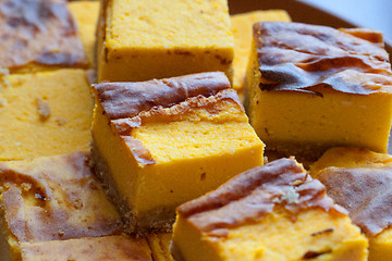 Image showing homemade yellow orange cheesecake in pieces