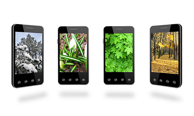 Image showing four smart-phones with colored images of seasons