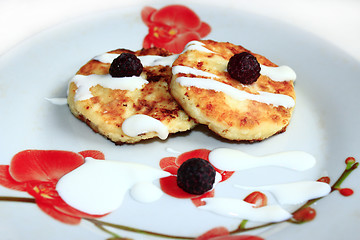 Image showing cheese cakes on the plate with raspberry