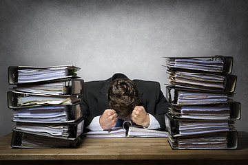 Image showing Overworked frustrated businessman