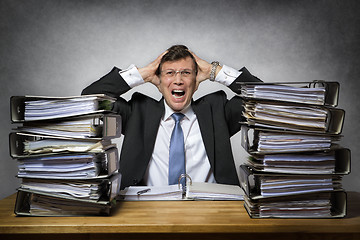 Image showing Overworked crying businessman