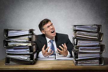 Image showing Overworked crying businessman