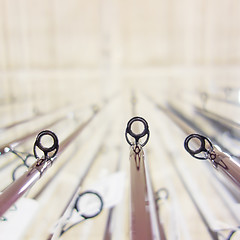 Image showing photo of row of fishing rods in store