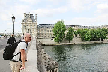 Image showing France, Paris - June 17, 2011: People walking in front of famous Louvre museum 