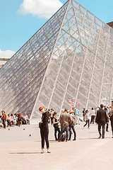 Image showing France, Paris - June 17, 2011: Redhead women near pyramid in Louver, Paris