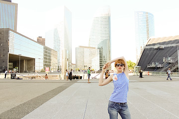 Image showing Young woman in Paris, looking at the La Grande Arche de la Defense