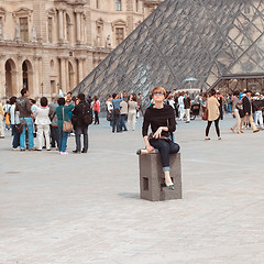 Image showing France, Paris - June 17, 2011: Redhead women near pyramid in Louver, Paris