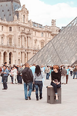 Image showing France, Paris - June 17, 2011: Redhead women near pyramid in Louver, Paris