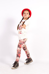 Image showing Little girl dance with a red hat with hand in front of you,