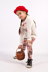 Image showing Little girl holding a basket in her hand