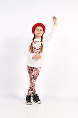 Image showing Little girl dance with a red hat with hand in front of you,