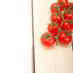 Image showing fresh cherry tomatoes on a cluster