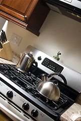 Image showing tea pot and coffee pot on stove