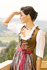 Image showing bavarian Girl in a dirndl on a balcony