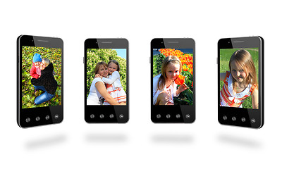 Image showing four smart-phones with colored images isolated