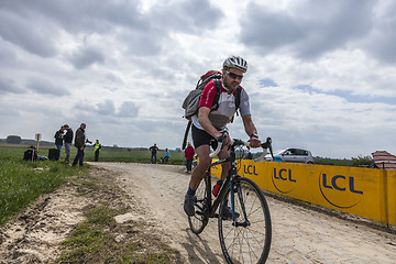 Image showing Amateur Cyclist Riding on a Cobblestoned Road