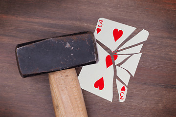 Image showing Hammer with a broken card, three of hearts