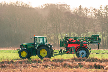 Image showing Tractor on a field with ferilizer