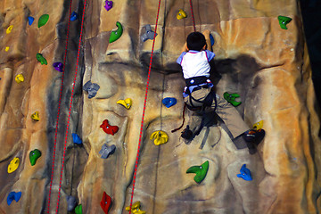 Image showing Little boy Climbing A Wall