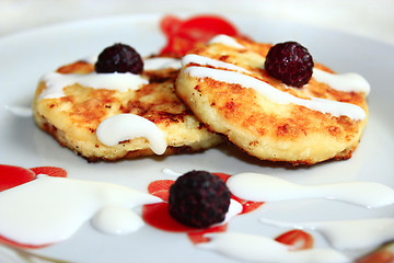 Image showing cheese cakes on the plate with raspberry