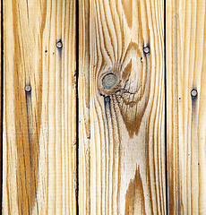 Image showing nail dirty stripped paint in the brown wood door and rusty yello