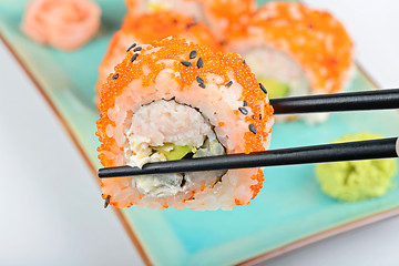 Image showing Sushi roll with black chopsticks 