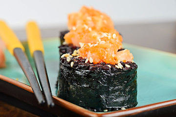 Image showing Baked sushi rolls served on turquoise plate