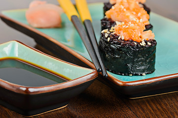 Image showing Baked sushi rolls served on turquoise plate