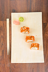 Image showing Sushi rolls on the wooden plate. Top view. 